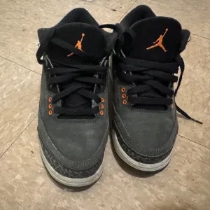 Jordan Black and Orange Sneakers with Iconic Design