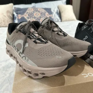 On Running Tan and Black Athletic Shoes with CloudTec