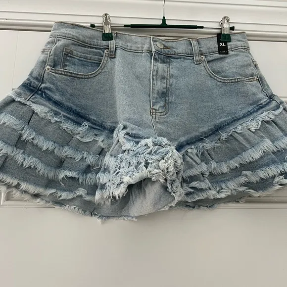 Work it Ms. thang in your booty-licious distressed ruffled denim shorts